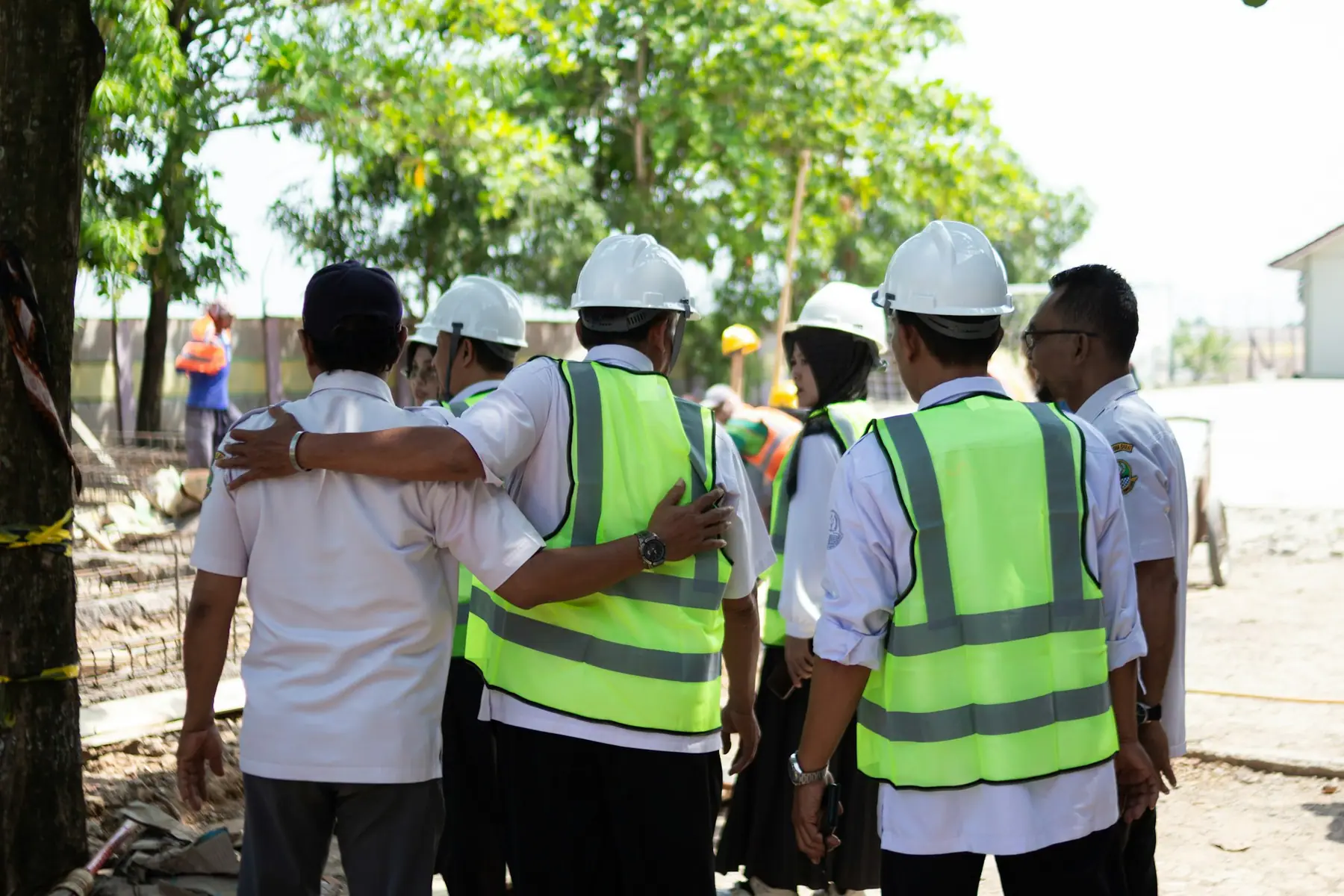 Construction crew in hard hats talking through the day's work